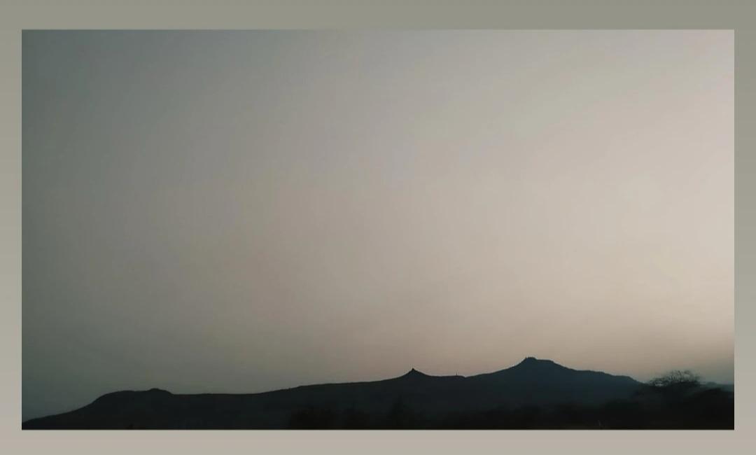 Hills at dusk — muted gradient sky, framed silhouette