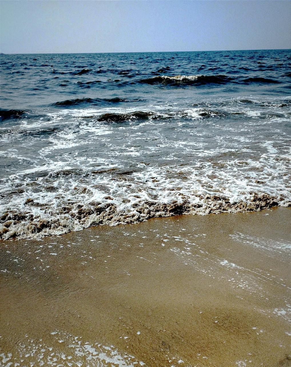 Surf meeting sand — foam line against the open sea